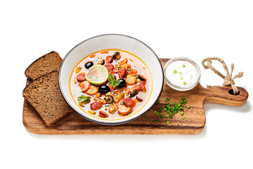 Traditional Russian meat soup Solyanka in bowl isolated on white background	