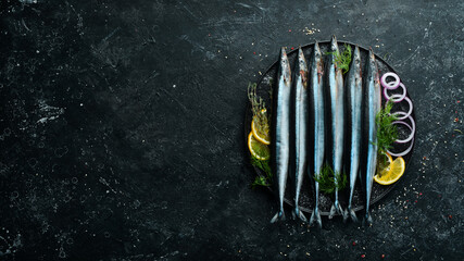 Raw fresh fish Saira with spices on a black stone plate. Seafood. On a dark background. © Yaruniv-Studio