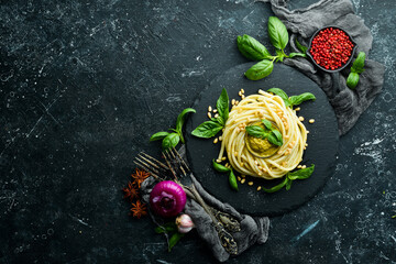 Pasta with pesto sauce, basil and pine nuts. Italian food. Top view.