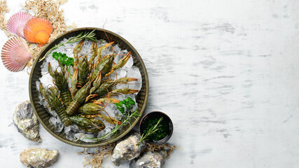 Fresh raw crayfish with spices on a white kitchen table. Top view. Flat lay.