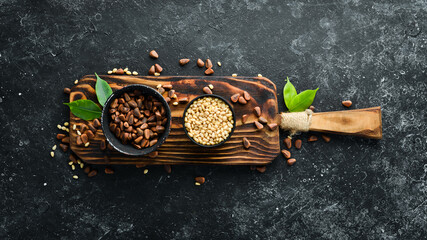 Pine nuts on a black stone background. Superfood. free space for your text. Top view.
