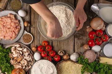Chef Prepares Dough Cooking Pie Background Ingredients Wooden Table Top View CookingThe chef prepares the dough for the preparation of the pie, on the background of the ingredients
