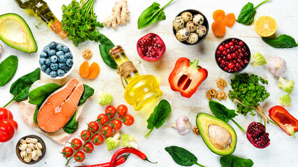 Food background. Healthy food for humans: vegetables, fruits, fish, meat, nuts and greens. on a...