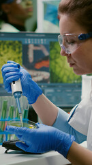 Biologist researcher using micropipette and petri dish to discovering gmo solution. Scientist...