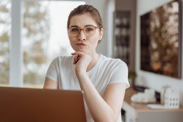 Confused or unsure young woman giving the camera a troubled look