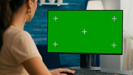 Close up of business woman use personal computer with mock up green screen chroma key. Freelancer...