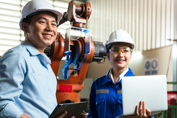 engineer cooperation Two asian male and female technician maintenance inspect relay robot system...