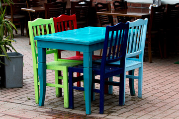  A retro designed colorful wooden table and chairs of a restaurant, empty and waiting for visitors