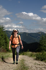 Naklejka premium young hiker man in mountains. summer trekking path