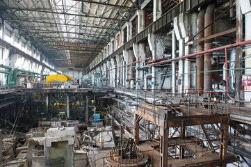 Petropavlovsk, Kazakhstan - 05.26.2015 : The territory of the power plant with large industrial compartments for turbine generators and pipes.