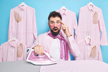 Scared stunned male employee wakes up in morning and irons clothes for work shocked as being late...