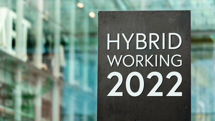 Hybrid Working 2021 sign in front of a modern office building