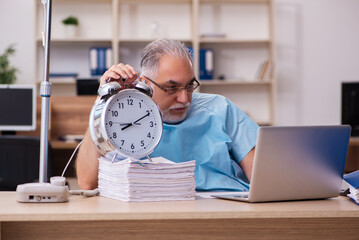 Old male employee in blood transfusion concept