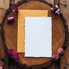 Wedding Flat lay. Wedding invitation set with card mockups for instagram. Wedding set with a yellow envelope and an invitation form on a wooden background with bush rose flowers. place for text