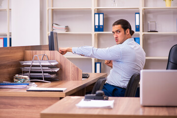 Young male employee working in the office