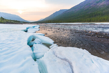 Snow and ice on the banks of the river Hoisey. Putorana Plateau, Taimyr