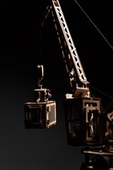 Fototapeta na wymiar Port crane made of wood on a black background