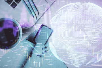 Double exposure of forex graph drawing over desktop background with computer. Concept of financial analysis. Top view.