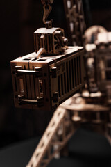 Port crane made of wood on a black background