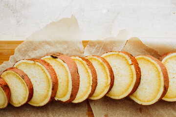round slices with skin of raw red sweet potatoes on baking paper. cooking homemade simple food, Yam recipes . selective focus