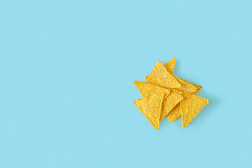 Traditional Mexican Nachos, corn tortilla chips on blue background. Flat lay composition, Copy...