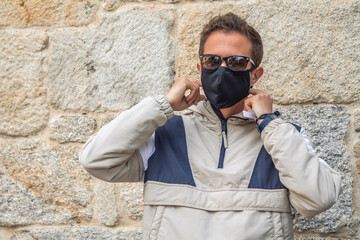 man with medical mask and sunglasses in the new normal