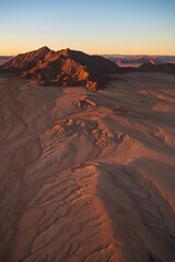 Fototapeta na wymiar The desert of Namibia, aerial view. Natural scenery for travel to Africa.