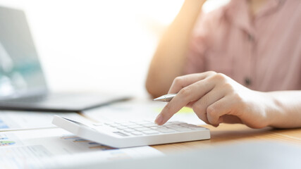 Accounting businesswomen are calculating income-expenditure and analyzing real estate investment data, Dedicated to the progress and growth of the company, Financial and tax systems concept.