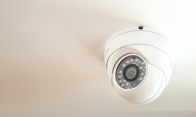 White Spherical CCTV camera in restaurant.Security systems and protection in Supermarket .CCTV on white background.
