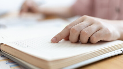 Dollar coins arranged in a slope graph, Blurred image of a businesswoman pressing a calculator, Take a notebook to record information, Saving money for business growth, Save money.