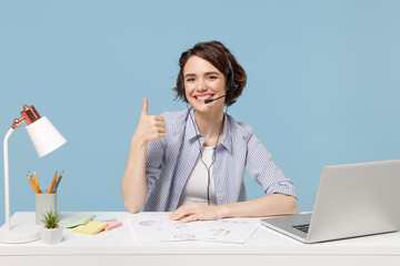 Young operator employee business woman in shirt set microphone headset for helpline assistance sit...