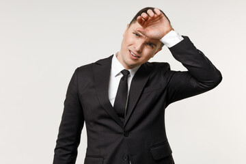 Young tired sick ill employee business corporate lawyer man 20s wearing classic formal black grey suit shirt tie working in office put hand on forehead isolated on white background studio portrait