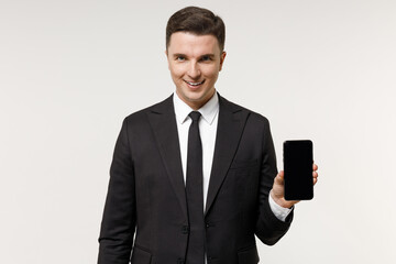 Young employee business corporate lawyer man wear classic formal black grey suit shirt tie work in office hold mobile cell phone with blank screen workspace area isolated on white background studio.