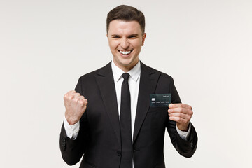 Young overjoyed successful rich employee business corporate lawyer man in classic formal black grey suit shirt tie work in office hold credit bank card do winner gesture isolated on white background.