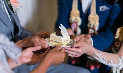 The bride and groom give the cake