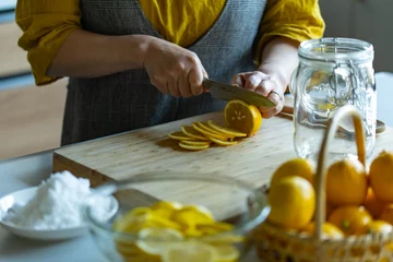 Foto op Canvas Woman making lemonade in kitchen.  © Tsurukame Design