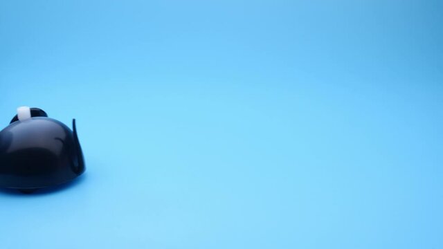 Clockwork mouse runs on a blue background. Seamless loop.