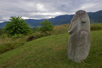 Fototapeta Mysterious ancient megalith known as Loga overlooking surrounding landscape, Lore Lindu National Park, Bada or Napu valley, Central Sulawesi, Indonesia obraz