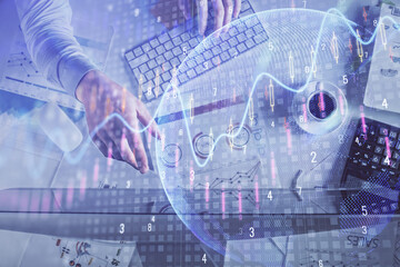 Multi exposure of man's hands typing over computer keyboard and forex graph hologram drawing. Top view. Financial markets concept.