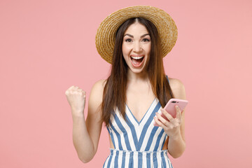 Young caucasian woman in summer clothes striped dress straw hat using mobile cell phone chat online...