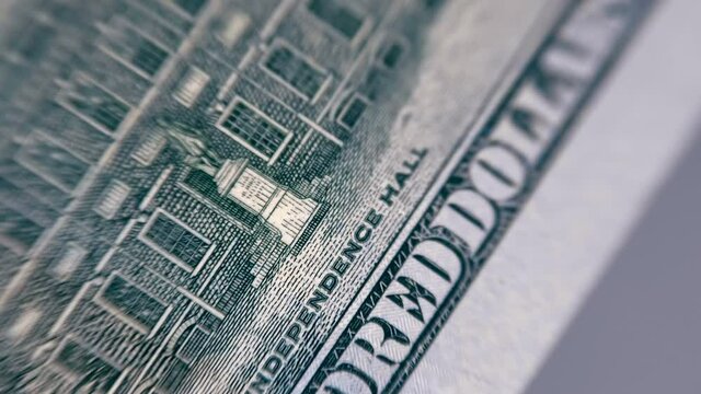 Texture of surface and detail of printing of the main elements of a hundred dollar bill. Macro. Closeup. Shot in motion. Shallow depth of field