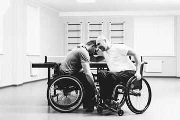 Adult disabled men hugs after playing table tennis