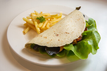 pork carnitas street tacos in yellow corn tortilla with avocado, onion, cilantro and cabbage