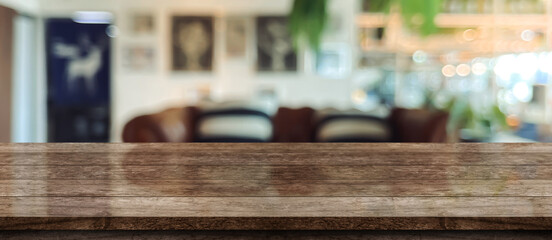 Empty wooden table top with lights bokeh on blur restaurant background.