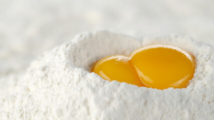 eggs in pile of flour close up. a bunch of flour with raw eggs