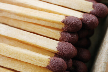 macro of wooden matchsticks in open matchbox