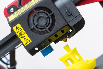 Close-up detail of 3D printer printerhead with hotend and fan. Isolated on white background.