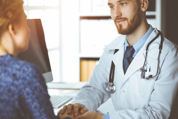 Friendly red-beard doctor reassuring his female patient. Medical ethics and trust concept, medicine theme