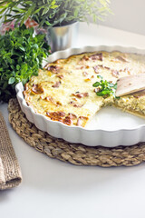 French onion pie with bacon in a baking dish, copy space. Authentic hobby homemade cakes, jellied pie with onions