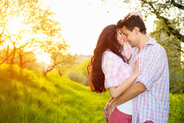 Happy couple in Love. Male and woman in sunset light. Love story - concept.